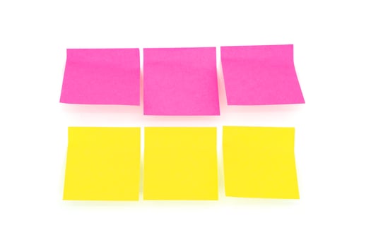 Reminder notes isolated on the white background. Yellow and pink sticky notes photo
