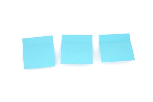 Three blue blank sticky notes on white background. Front view photo