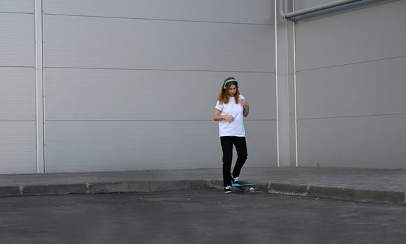 Beautiful and blonde girl practicing long board on the bridge photo