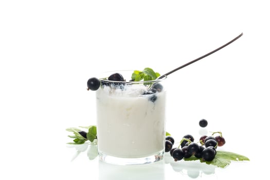 Healthy fermented milk product with berries and spoon on white background photo