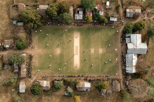 An aerial view of a cricket field with people playing photo