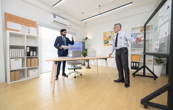 In a contemporary office, two senior executives with a mission to brainstorm and monitor,56 photo