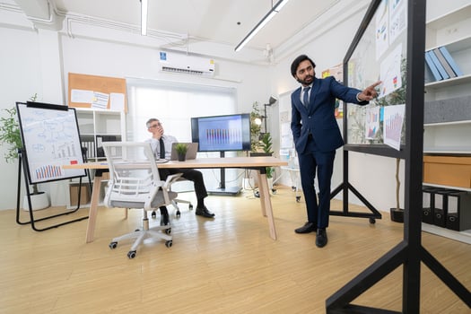 In a contemporary office, two senior executives with a mission to brainstorm and monitor,19 photo