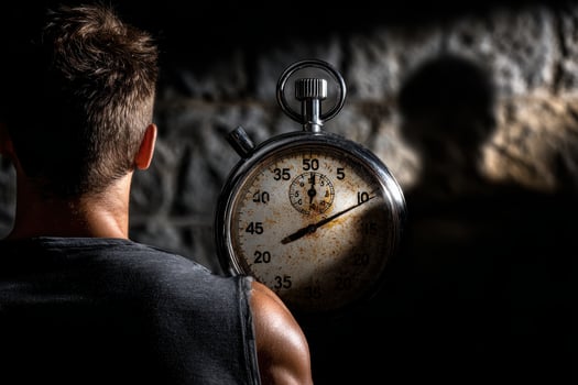 Human shadow reflects time anxiety against a giant stopwatch photo