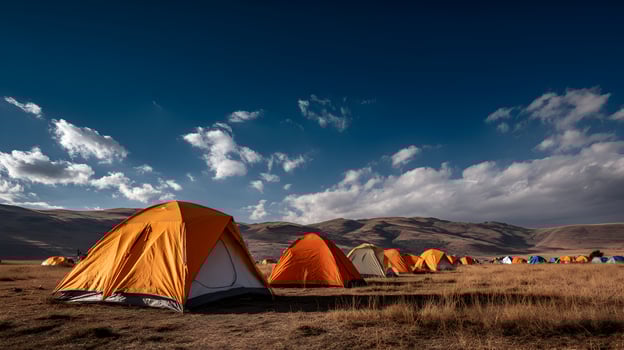 A vibrant collection of tents stretches across a serene landscape under a beautiful cloudy sky photo
