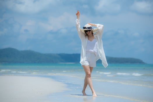 Young woman on vacation on a white sandy beach, clear sky and sea,130 photo