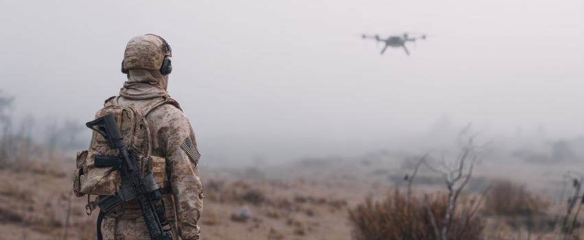The soldier observing a drone in a foggy landscape during a military operation. photo