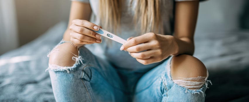 The woman holding a pregnancy test, capturing emotions of anticipation and hope. photo