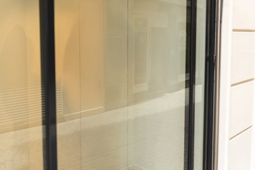 Reflective shop window with neutral tones and blurred background, great for branding mockups, store visuals or advertising real estate content photo