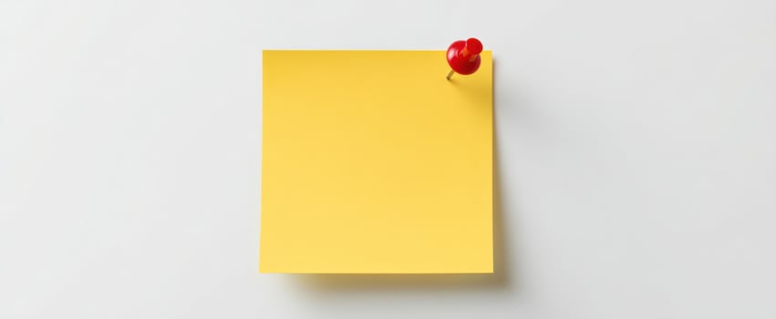The yellow sticky note with a red pushpin on a minimalist background photo