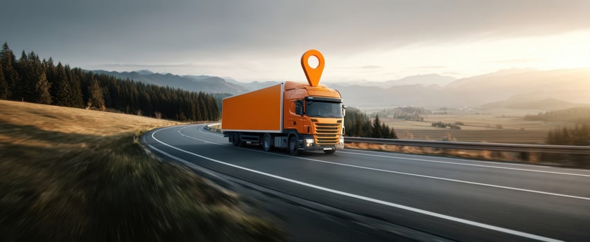 The orange truck driving through a scenic landscape with a location pin. photo