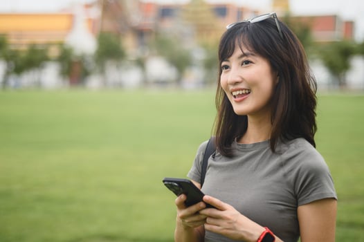 Happy solo southeast asian woman teenager blogger and explorer use smartphone map guide to explore Bangkok. world travel tourism concept offers local cultural experience in Thailand Asia photo