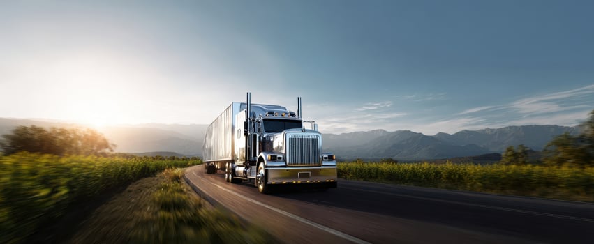 The majestic truck traveling along a scenic highway under a clear sky. photo
