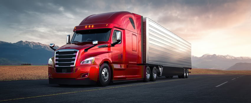 The striking red truck parked on an open highway amidst majestic mountains. photo
