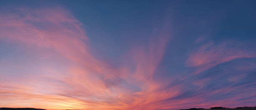 The breathtaking sunset painting the sky with vibrant colors and soft clouds. photo