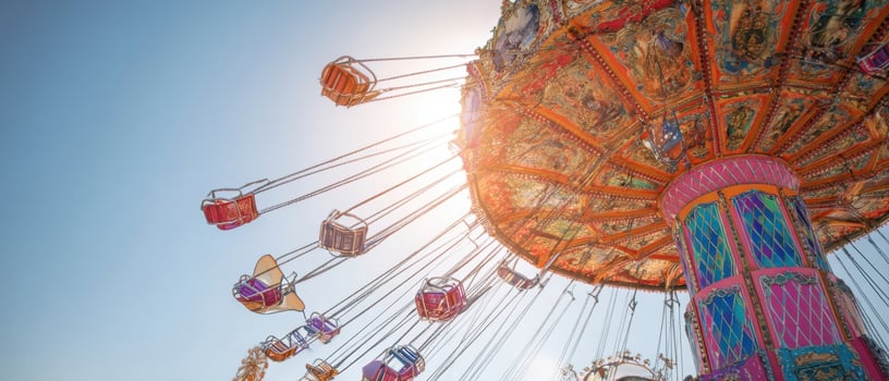 The colorful swing ride spinning joyfully under the bright summer sun. photo