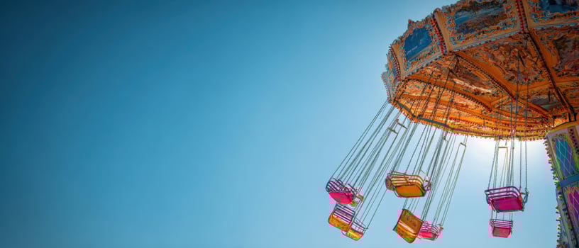 The colorful swing ride against a clear blue sky during a lively carnival event. photo
