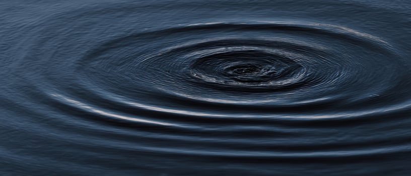 The mesmerizing ripple effect on a tranquil water surface. photo