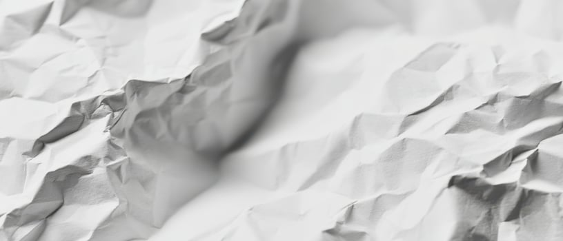 The elegant texture of crumpled white paper showcasing intricate details and patterns. photo