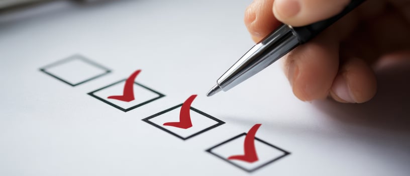 The pen marking checkboxes on a productivity checklist for task completion. photo