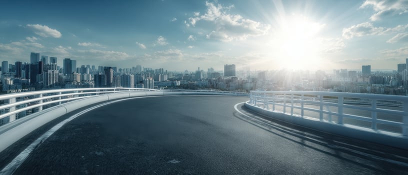 The sweeping road curving through a vibrant cityscape at sunrise. photo
