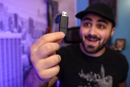Young man holding a USB flash drive photo
