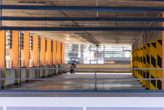 Empty Parking Garage Interior with Painted Yellow and Black Support Pillars photo