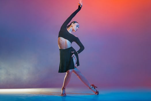 Latin Female Dancer in Black Performing Artistic Graceful Pose Studio Modern Latin American Dance photo