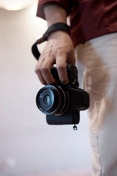 close up photographer holding camera with right hand photo