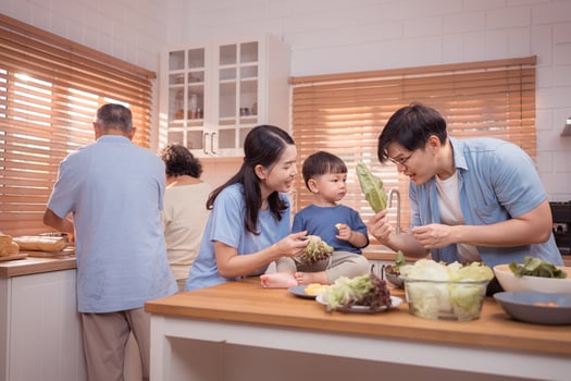 Happy Asian family preparing food together in a bright kitchen,92 photo
