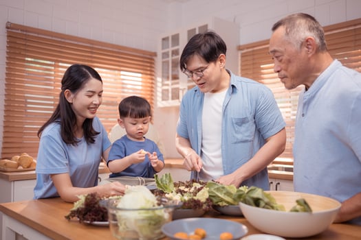 Happy Asian family preparing food together in a bright kitchen,62 photo