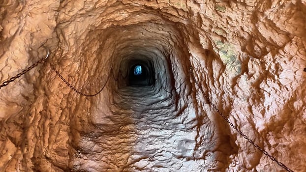 Delve into the intriguing depths of a mesmerizing underground tunnel characterized by its textured walls photo