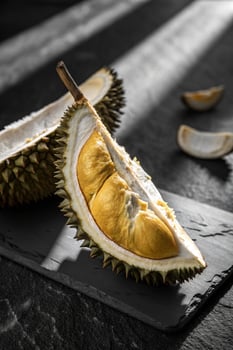 Ripe Durian Fruit on Dark Slate, Close-Up Exotic Food Still Life photo