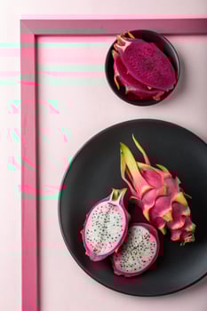 Pink Dragon Fruit Slices on Black Plates, Minimalist Still Life photo