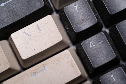 Close-up shot of square key caps in gray and black. Macro Photography of mechanical keyboard with two unique and cool colors. Dirty keycaps with dirt and crust closeup. Technology Themes photo