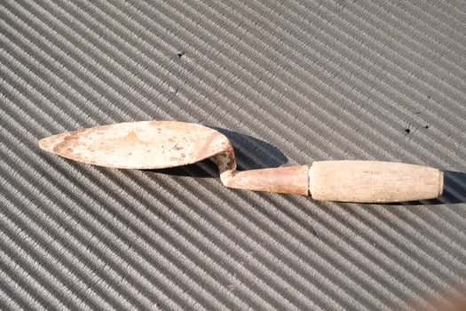 A rusty trowel with a wooden handle isolated on black backgrounds. Hand shovel used for planting plants in pots or digging soil. Tool and equipment for gardening . Graphic resources. Negative space photo