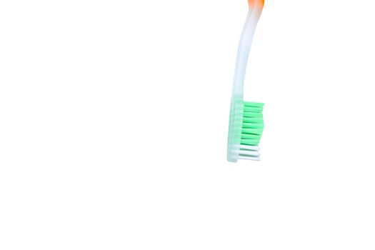 Green toothbrush with orange handle for cleaning photo