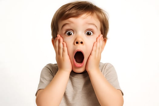 A young boy is making a surprised face photo