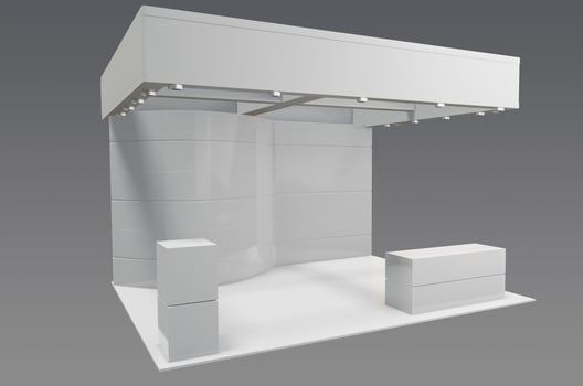 A white display booth with a white table and chairs photo