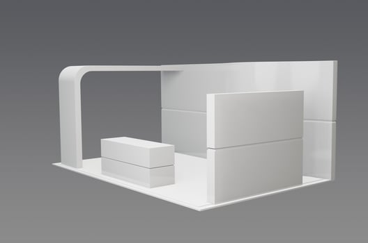 A white display booth with a table and chair photo