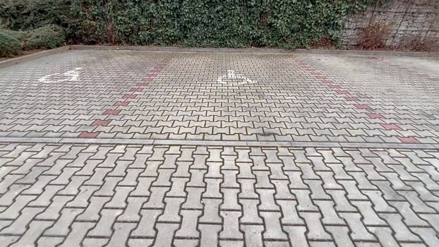 The paved parking area is designed with clear symbols indicating accessibility features and designated spaces photo