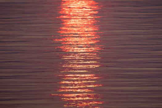 A Vibrant Sunset Reflection on Tranquil Waters photo