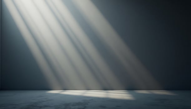 Sunlight Streaming Into an Empty Room with Concrete Floor and Wall photo