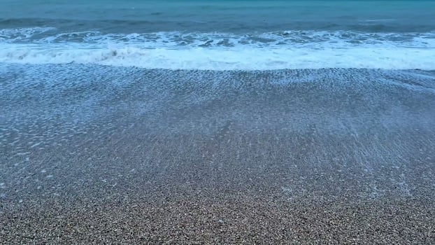 Immerse yourself in the serene and calming beauty of gentle waves softly lapping at the shore at twilight photo