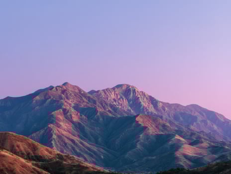A Mountain Range With A Gentle Pink Sunset photo