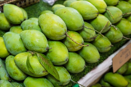 Tropical fresh green mango sale in market, vibrant unripe mangoes full of vitamin c perfect photo