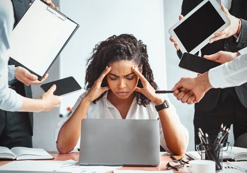 Multitasking. Overworked Afro Businesswoman Sitting Touching Head Ignoring Colleagues Tired Of Multiple Tasks At Work In Modern Office. photo