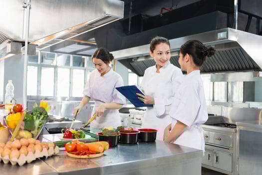Chefs collaborating in a modern kitchen photo