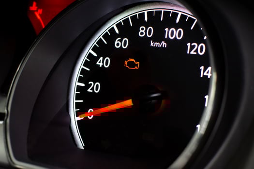 Check Engine Light Close Up, A car speedometer with an illuminated orange check engine light photo