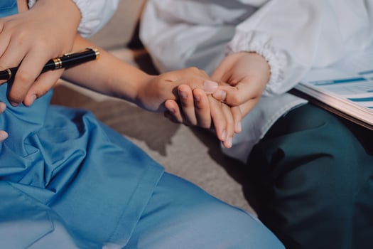 A doctor holding a pen and a patient's hand photo